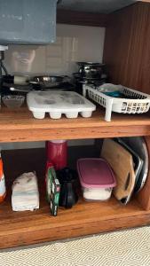 a shelf with dishes and other items on it at Tiny House Armação no Morro in Florianópolis +17 photos