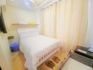 a bedroom with a bed with two donuts on the floor at Serenity Gardens,pool retreat, Kigamboni in Dar es Salaam +21 photos
