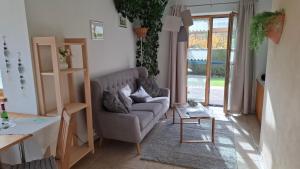 a living room with a couch and a table at Ferienwohnung Oswald in Unterammergau +13 photos