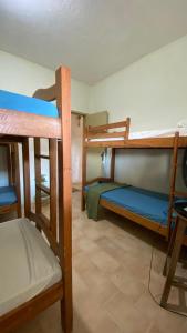 een kamer met 3 stapelbedden in een kamer bij FLOR DE ARUANDA - Hostel e Acampamento in Cabo de Santo Agostinho