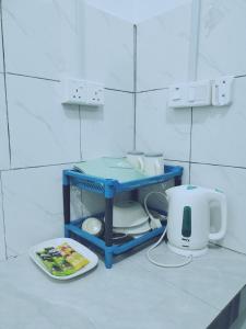 a bathroom with a counter with a sink and a toaster at Homestay Rezquna Deluxe Studio in Beaufort
