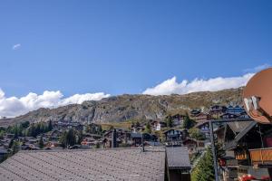 a view of a town in front of a mountain at Chalet Mazze in Bettmeralp +19 photos