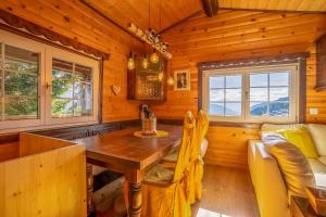 a dining room with a wooden table in a cabin at Chalet Mazze in Bettmeralp