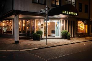 a building with a maks show on a city street at Max Brown Hotel Midtown, part of Sircle Collection in Düsseldorf