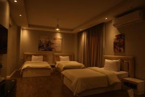 a hotel room with two beds in a room at Munir`s residence 2 in Cairo