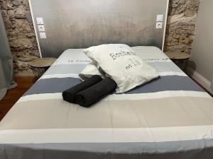 a bed with two pillows on top of it at Le Cocon Authentique in Mont-de-Marsan