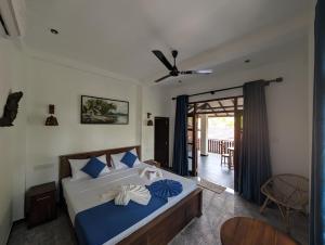 Postel nebo postele na pokoji v ubytování Little Villa Habaraduwa