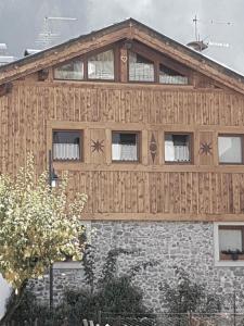 a house being built with wood panels on it at VHĀUS Apartment and Spa in Predazzo