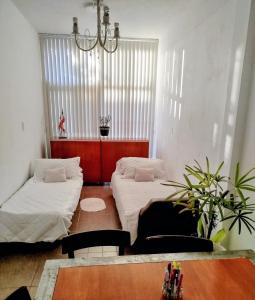 En eller flere senge i et værelse på Estilo y confort en San Nicolás