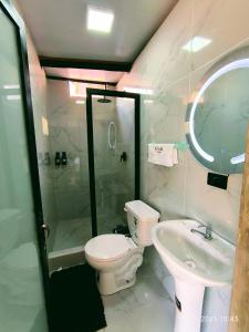 a white bathroom with a toilet and a sink at RioVida EcoLodge in Nueva Tarqui +48 photos