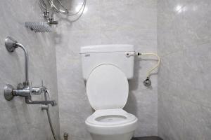 a bathroom with a toilet in a stall at Relax Hotel Kurla in Mumbai
