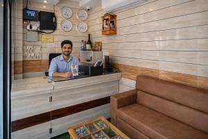 a man sitting at a counter in a restaurant at Relax Hotel Kurla in Mumbai