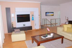 a living room with a couch and a coffee table at Keke Place in Vila Praia Do Bilene