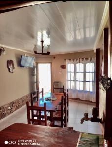 a dining room with a table and chairs in a room at Apart Hotel Rústicos Valentina in Dolores
