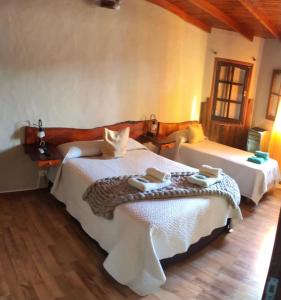 a bedroom with two beds in a room at Apart Hotel Rústicos Valentina in Dolores