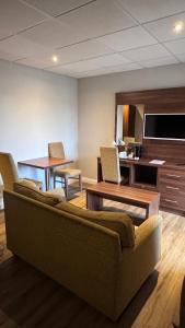 a living room with a couch and a table at The March Hotel in March