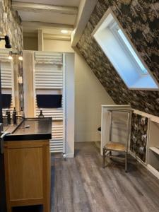 a kitchen with a sink and a skylight at Chambre d'hôte chez Hélène in Kaysersberg