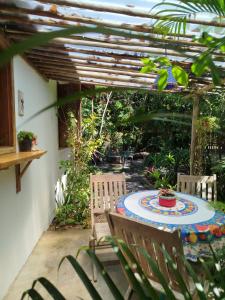 a patio with a table and chairs and a pergola at Campo das Margaridas Santo Andre in Santo André +13 photos