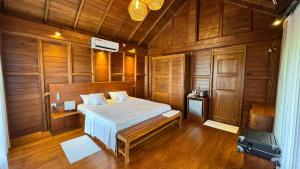 a bedroom with a bed in a wooden room at Ceylon Elegance Villa in Kurunegala