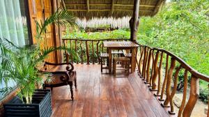 a wooden deck with a table and chairs on a porch at Ceylon Elegance Villa in Kurunegala +10 photos