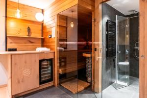 a bathroom with a walk in shower and a glass shower stall at Zacisze Gór by Apart Concept Podhale in Zakopane +30 photos