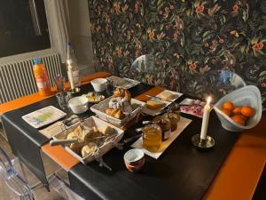 a table with food and candles on top of it at Chambre d'hôte chez Hélène in Kaysersberg