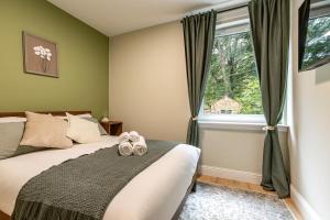a bedroom with a bed with shoes on it at Yarrow cottage in Broadmeadows