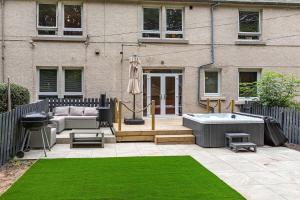 a backyard with a hot tub and a house at Yarrow cottage in Broadmeadows