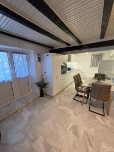a kitchen and dining room with a table and chairs at Appartment by Eftymia in Nea Roda