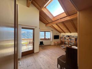 a living room with a large window and a view of the mountains at Dolomiten View - South Tyrol in Villandro