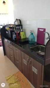 a kitchen with a black counter top and a sink at Aarex 63B Sparsh Chalet in Dhamni