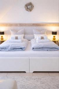 a large white bed with two pillows on it at Weberhof - Münster 3 in Münster