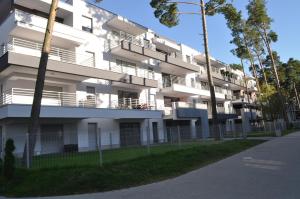 an apartment building with balconies and a street at Apartament Sweet Home Pogorzelica in Pogorzelica