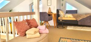 a living room with a couch with pillows on it at Haus Theda in Fockbek