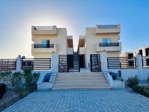 a building with stairs in front of it at Traveller Namma bay in Sharm El Sheikh