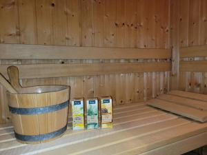 a sauna with a bucket and two boxes of milk at Sonneninsel Wiek mit eigener Sauna und Fahrradgarage inkl Wäschepaket in Wiek auf Rügen