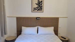 a bed with two white pillows in a bedroom at hotel de la gare in Modane
