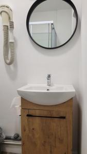 a bathroom with a sink and a mirror on the wall at hotel de la gare in Modane