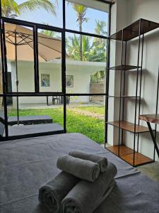 a group of towels laying on a bed in a room at VODA Hotel in Galle