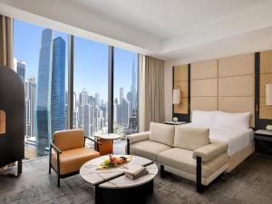 a hotel room with a bed and a large window at Anantara Downtown Dubai in Dubai +51 photos