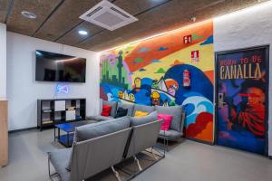 a waiting room with a mural on the wall at Malacuna Barcelona in Barcelona +64 photos
