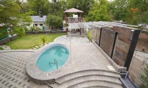 a backyard with a plunge pool and a gazebo at Arpan Villa in Aurangabad