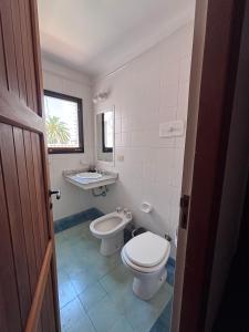 a bathroom with a toilet and a sink at Beach House AP in Miramar +30 photos