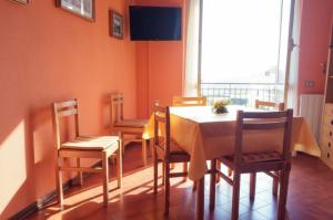 a dining room with a table and chairs and a window at Condominio Ariazzurra S. Bart. in San Bartolomeo al Mare
