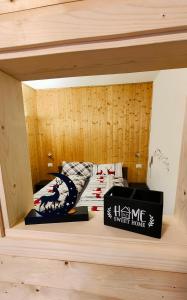 a room with a bed with a box on a shelf at Casa Producena in Valdidentro