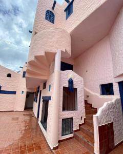 un edificio con una scala di fronte di Hotel Pueblo Alegre a Huamboya