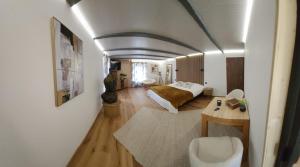 a bedroom with a bed and a table in a room at Chambre d'hôte de la Source Bleue in Cusance