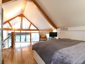 a bedroom with a bed and a large window at The Lodge Lodge Farm in Bedford