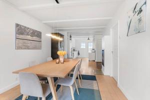 a dining room with a wooden table and chairs at LL264-Bagenkop-Faergevej-9-1-th in Bagenkop +13 photos