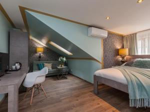 a bedroom with a bed and a desk with a chair at Gorgeous Prague Rooms in Prague